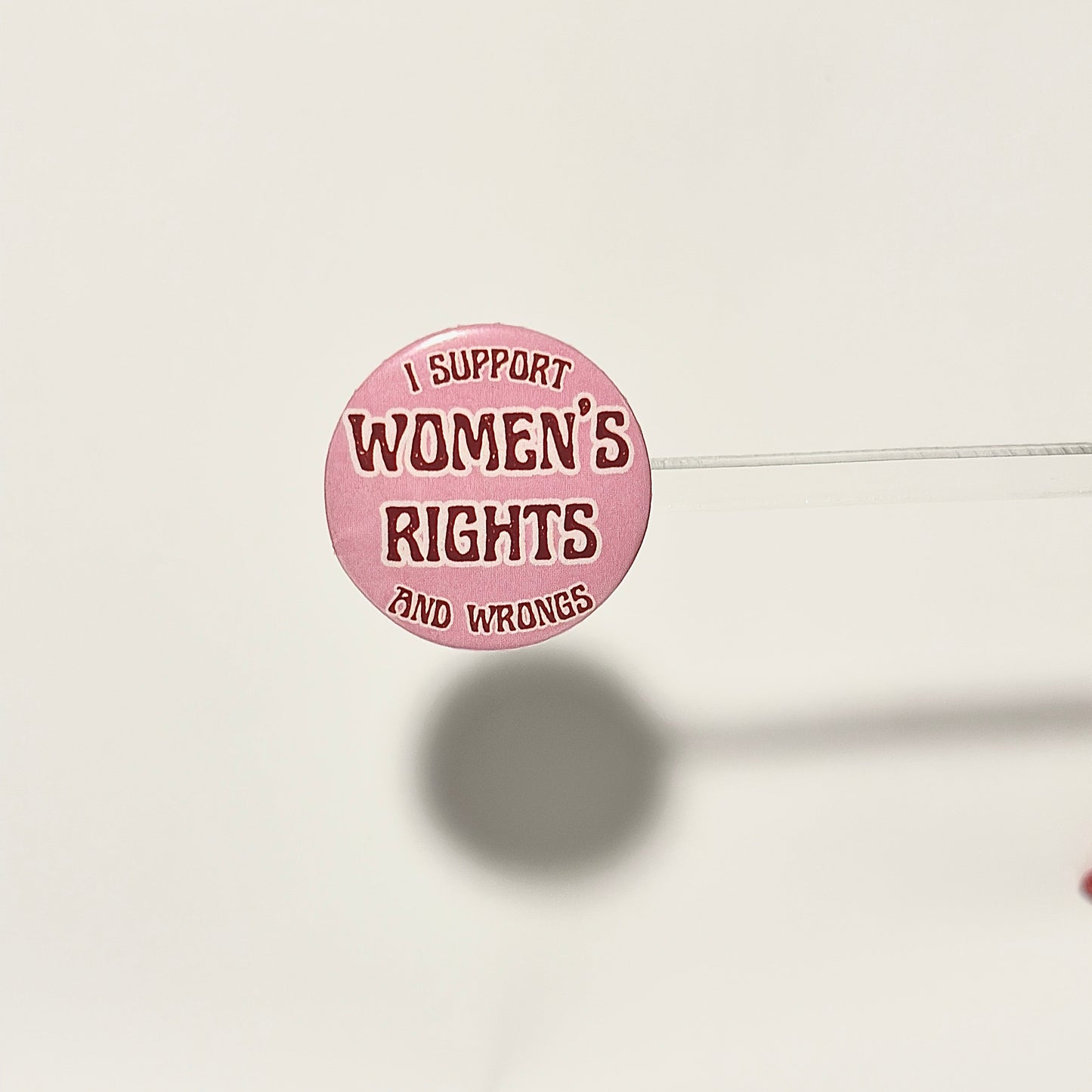 Pink button with 'I Support Women's Rights and Wrongs' text in marroon