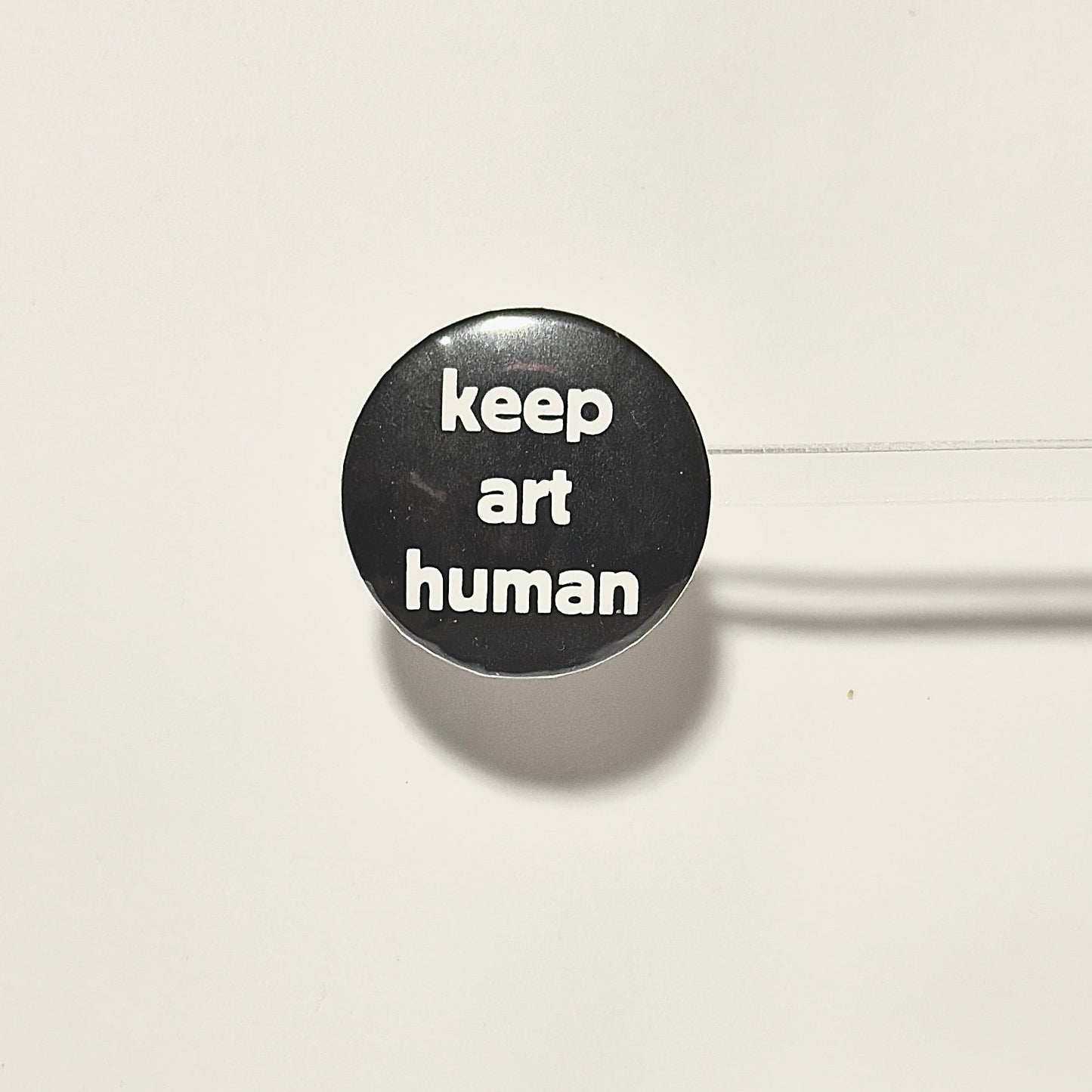 Black button with 'keep art human' in white text 