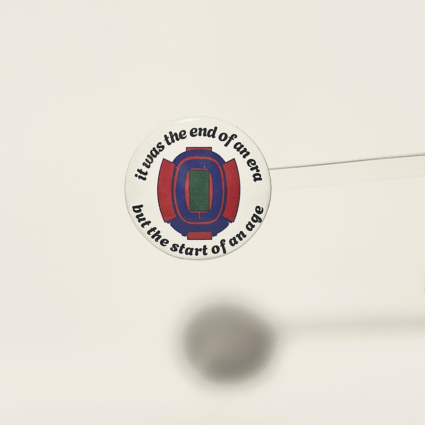 pinback button with arched text that reads it was the end of an era but the start of an age with a hand drawn version of the iconic buffalo bills stadium known as The Ralph. design is on a white background