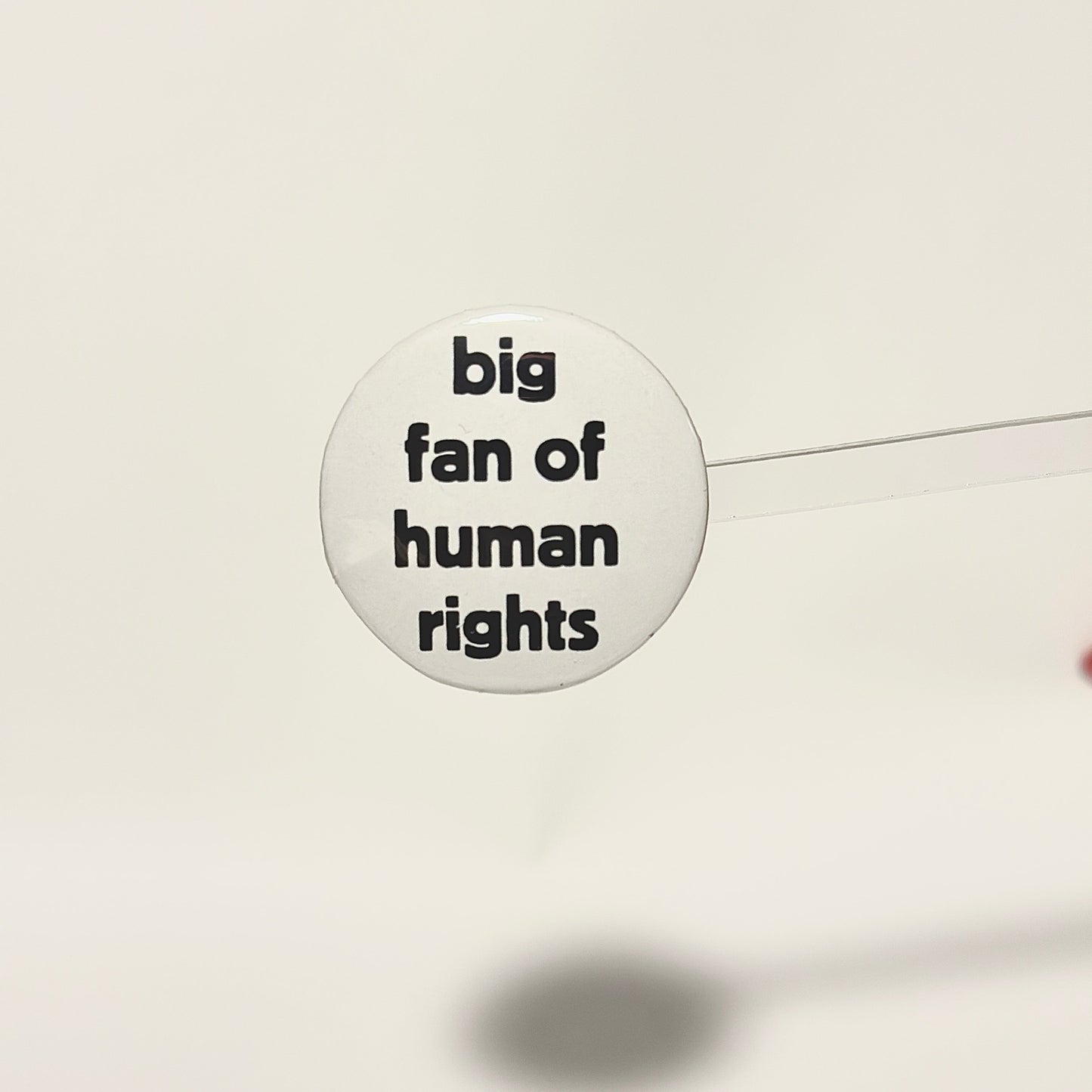 Button badge with 'big fan of human rights' black text on a white background