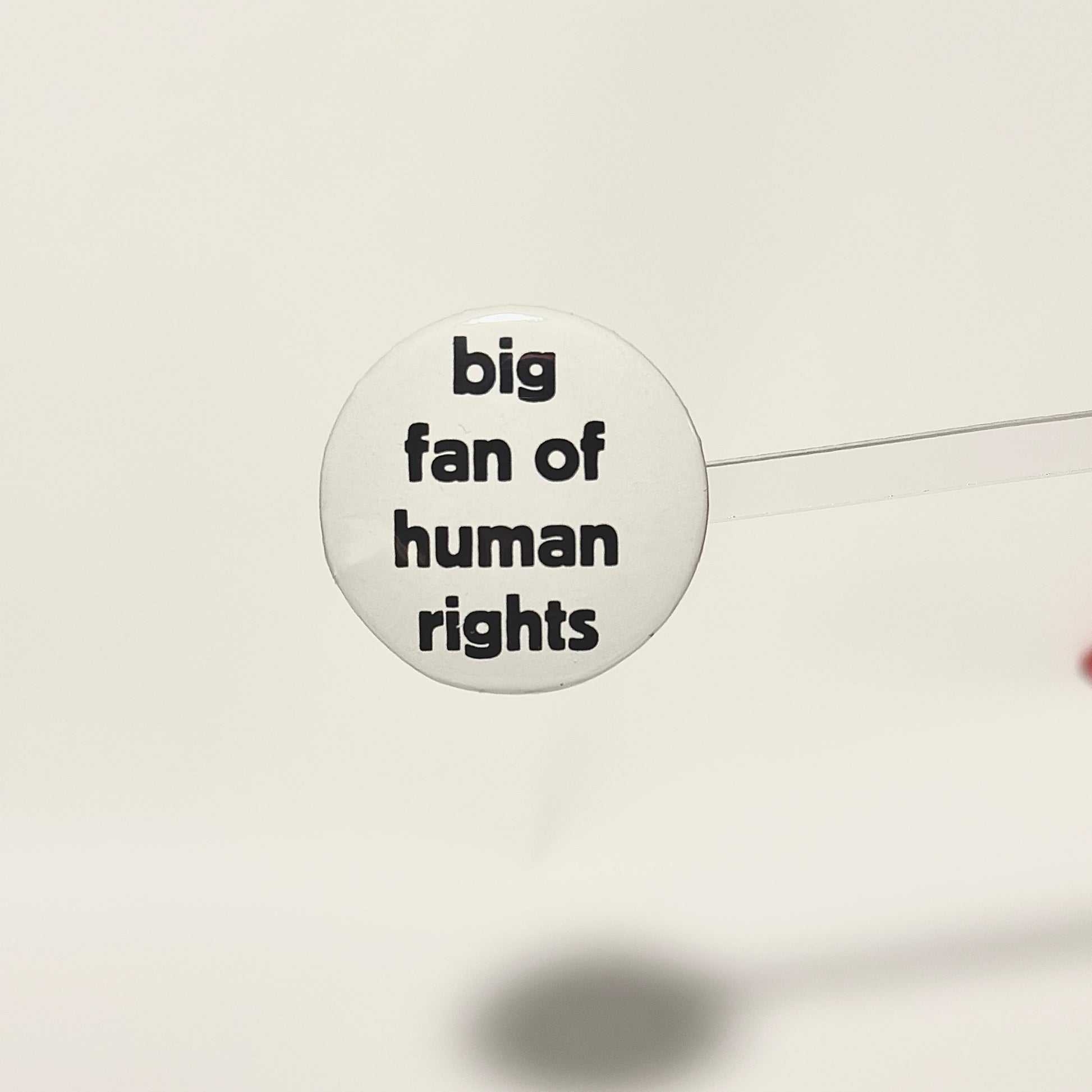 Button badge with 'big fan of human rights' black text on a white background
